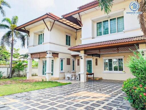 Spacious two-story suburban house with a tiled front yard and greenery