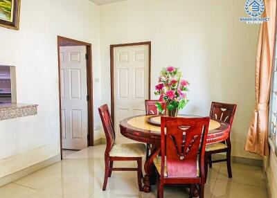 Bright dining room with round wooden table and chairs