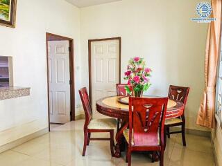 Bright dining room with round wooden table and chairs