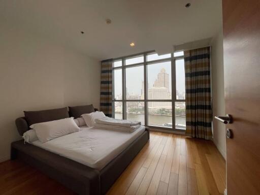 Spacious bedroom with large windows and city view