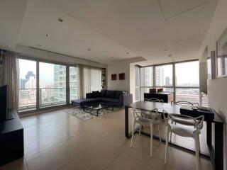 Spacious and well-lit living room with modern furniture and city view