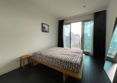 Modern bedroom with large windows and city view