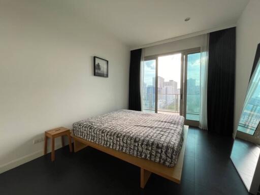 Modern bedroom with large windows and city view