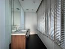 Modern bathroom with large window and blinds