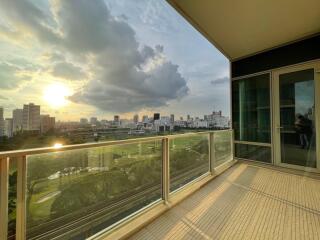 Spacious balcony with city view at sunset