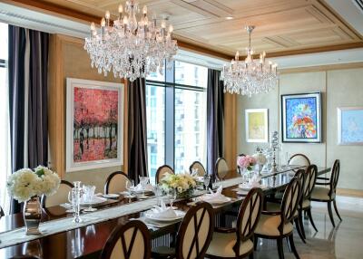 Luxurious dining room with chandeliers and art-adorned walls