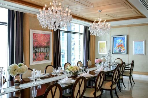 Luxurious dining room with chandeliers and art-adorned walls