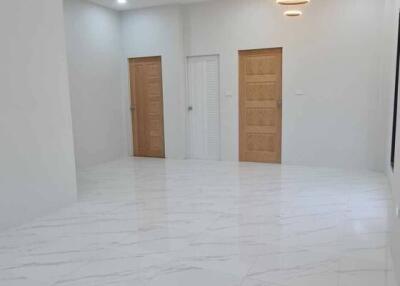 Spacious and well-lit empty interior space with glossy tiled flooring