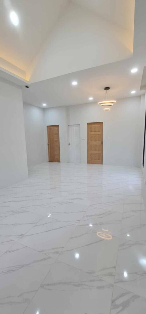 Spacious and well-lit empty interior space with glossy tiled flooring