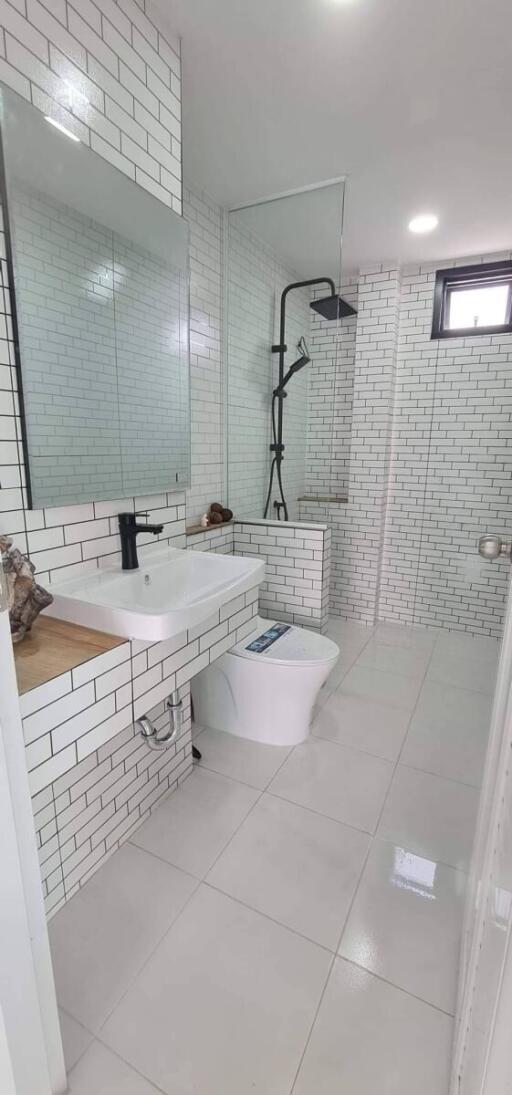 Modern bathroom with white subway tiles and walk-in shower