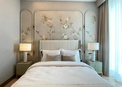 Elegantly decorated bedroom with floral wall design and modern furnishings