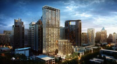 Modern high-rise residential building in an urban skyline at dusk