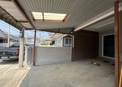 Spacious carport area with metal roofing and concrete flooring