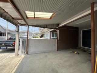 Spacious carport area with metal roofing and concrete flooring