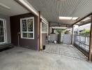 Spacious covered patio with concrete flooring and utility area