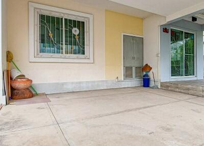 Bright and clean front porch of a residential building with window and door