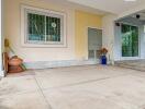 Bright and clean front porch of a residential building with window and door