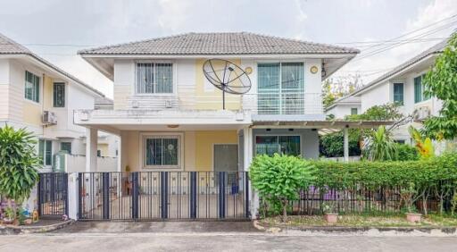 Two-story suburban house with a front gate and garden