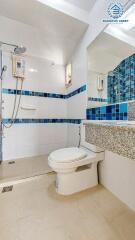 Modern bathroom with wall mounted shower and mosaic tiles