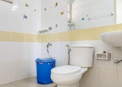 Clean bathroom with white ceramics and decorative tiles