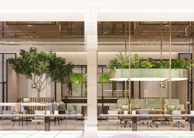 Modern building interior with open-plan layout, dining tables, and lush greenery
