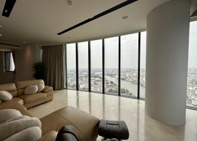 Spacious living room with large windows offering an expansive city and river view