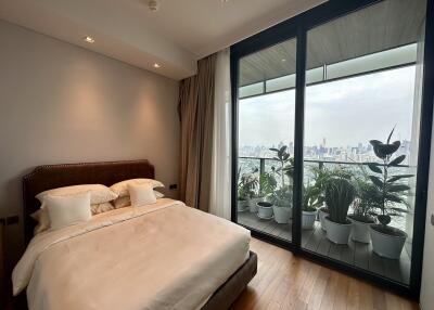 Modern bedroom with large windows and city view