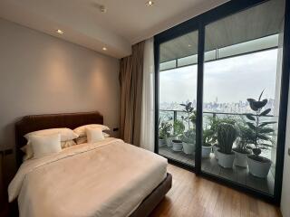 Modern bedroom with large windows and city view