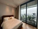 Modern bedroom with large windows and city view