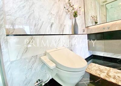 Modern bathroom with marble walls and high-tech toilet