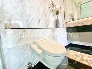 Modern bathroom with marble walls and high-tech toilet