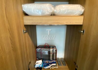 Wooden closet with storage items and branded packaging
