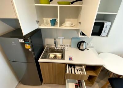 Compact modern kitchen with appliances and white cabinetry
