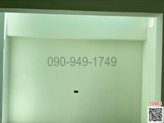 Blank wall with advertisement numbers and QR code