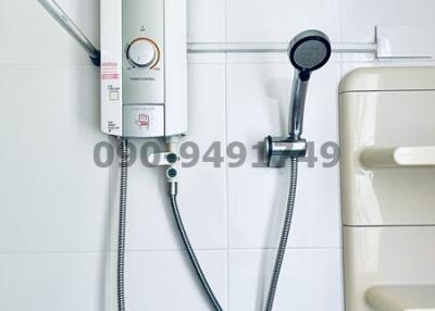 Modern water heater system with shower head and bathroom fixtures