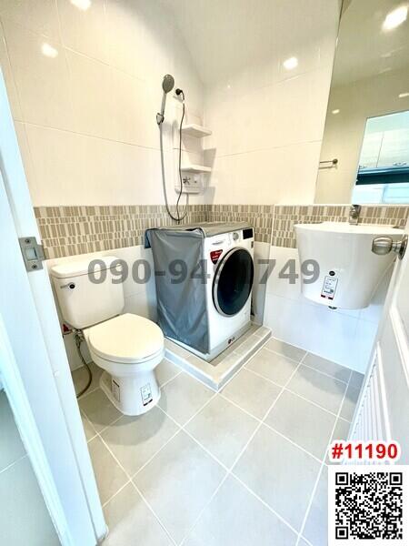 Modern bathroom with washing machine and toilet