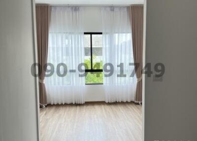Bright bedroom with large window and curtains