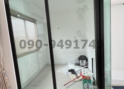 Sliding glass door leading to an interior room with construction materials