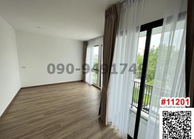 Spacious bedroom with large window and balcony access