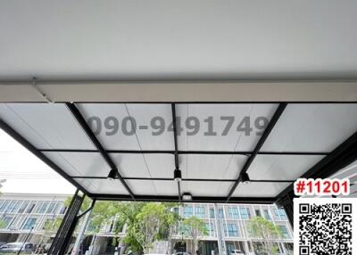 Modern patio cover with black frame and transparent panels