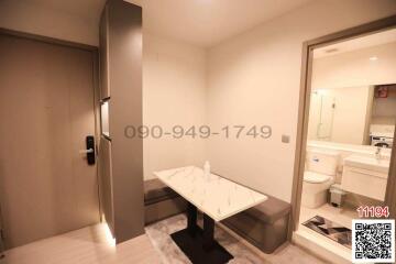 Modern entrance hall with marble table and bathroom access