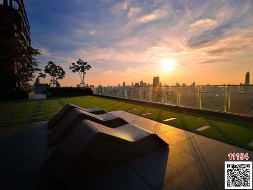 Sunset view from rooftop garden with seating