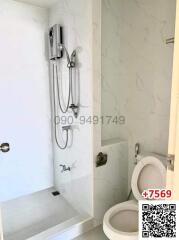 Modern bathroom with wall-mounted shower and toilet