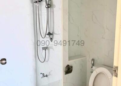 Modern bathroom with wall-mounted shower and toilet