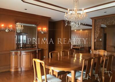 Elegant dining room with large wooden table and ornate chandelier
