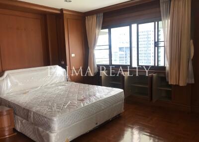 Spacious bedroom with large windows and ample natural light