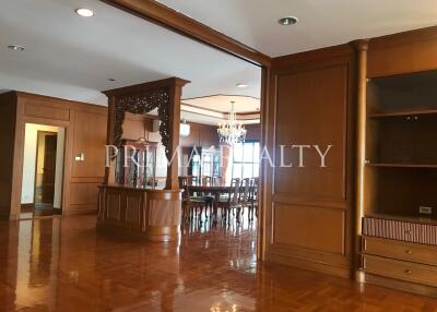 Spacious and elegant living room with dining area and hardwood floors
