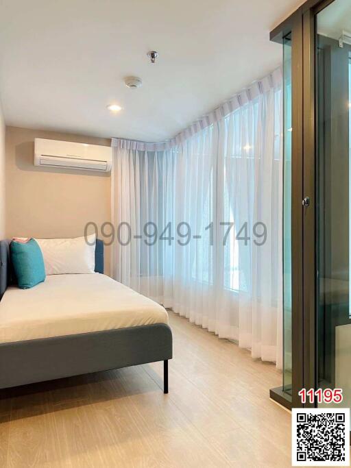 Modern bedroom with natural lighting and air conditioning