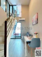 Modern interior design of a spacious building entryway with staircase and dining area