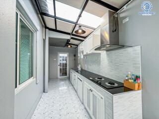 Modern kitchen with stainless steel appliances and white cabinetry